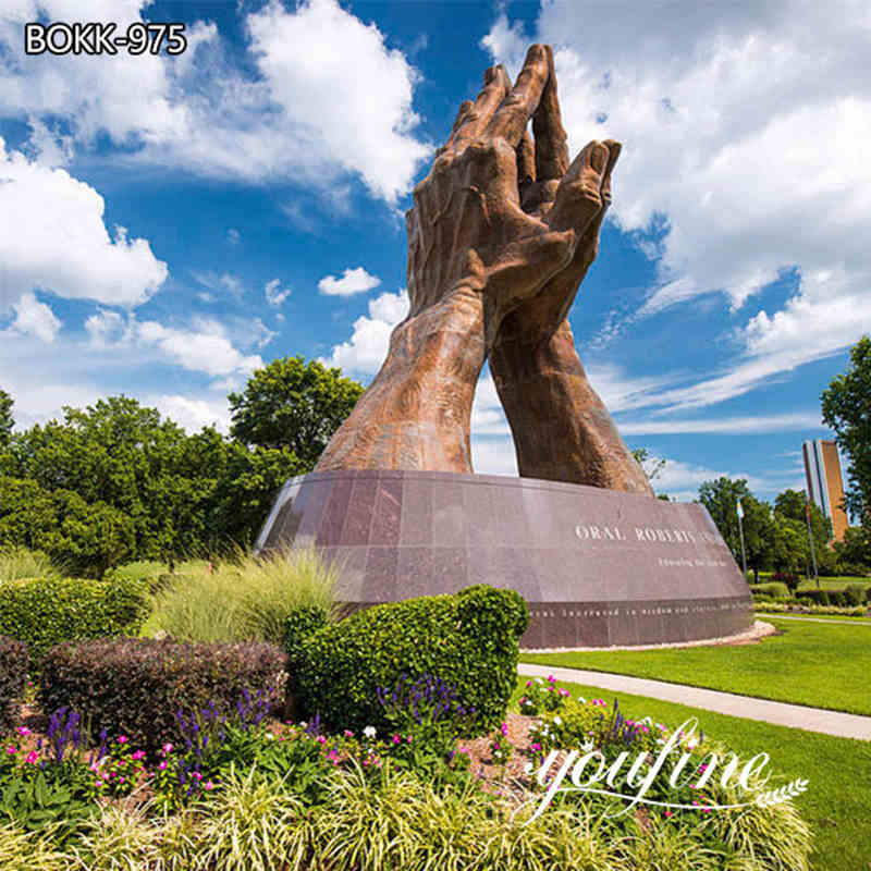 large praying hands sculpture